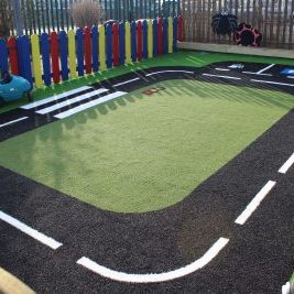 Roadway playground design with artificial grass