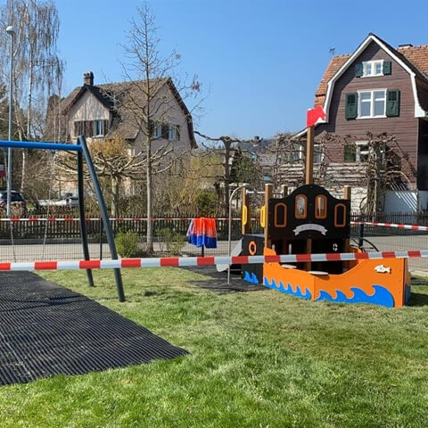 Playground with rubber mats around boat themed equipment