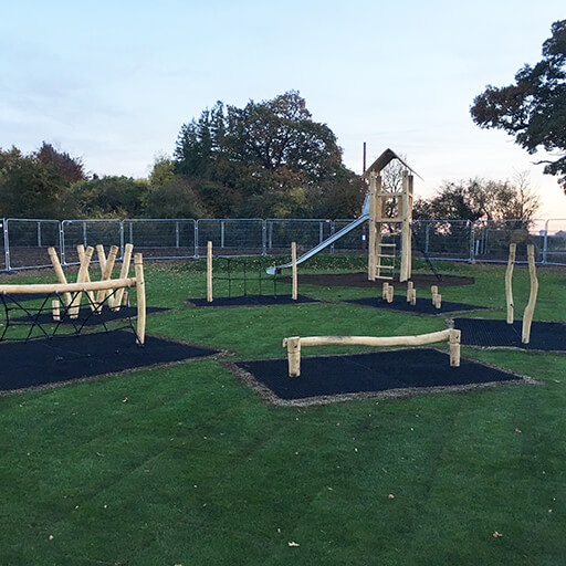 Grass mats underneath playground equipment in play field